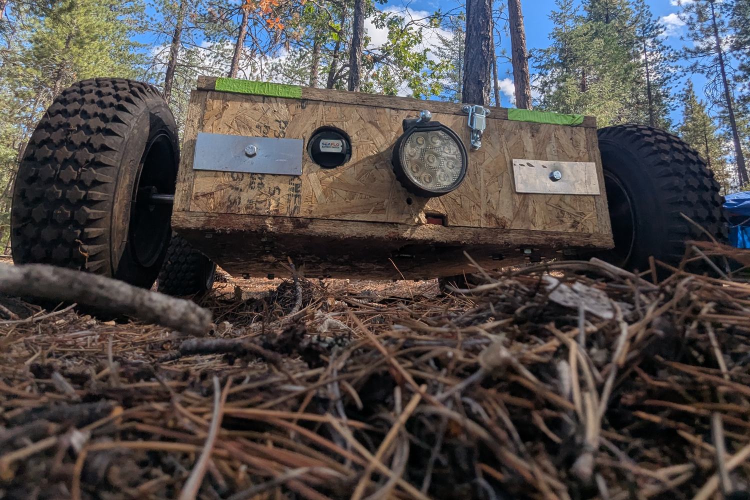 Low front view of the machine showing the work light, front frame and tyres